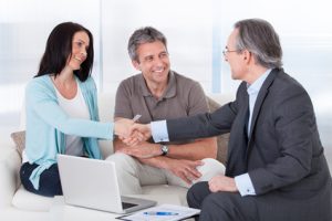 Portrait Of Mature Consultant Shaking Hand With Happy Woman